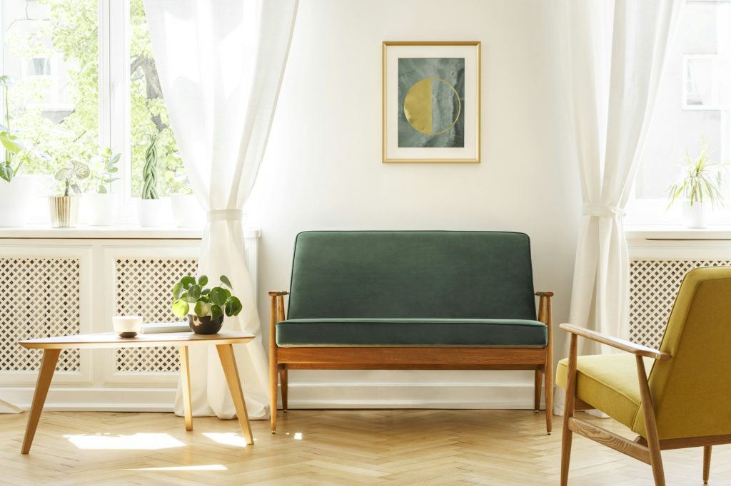 Real photo of a mid-century living room interior with a sofa, co